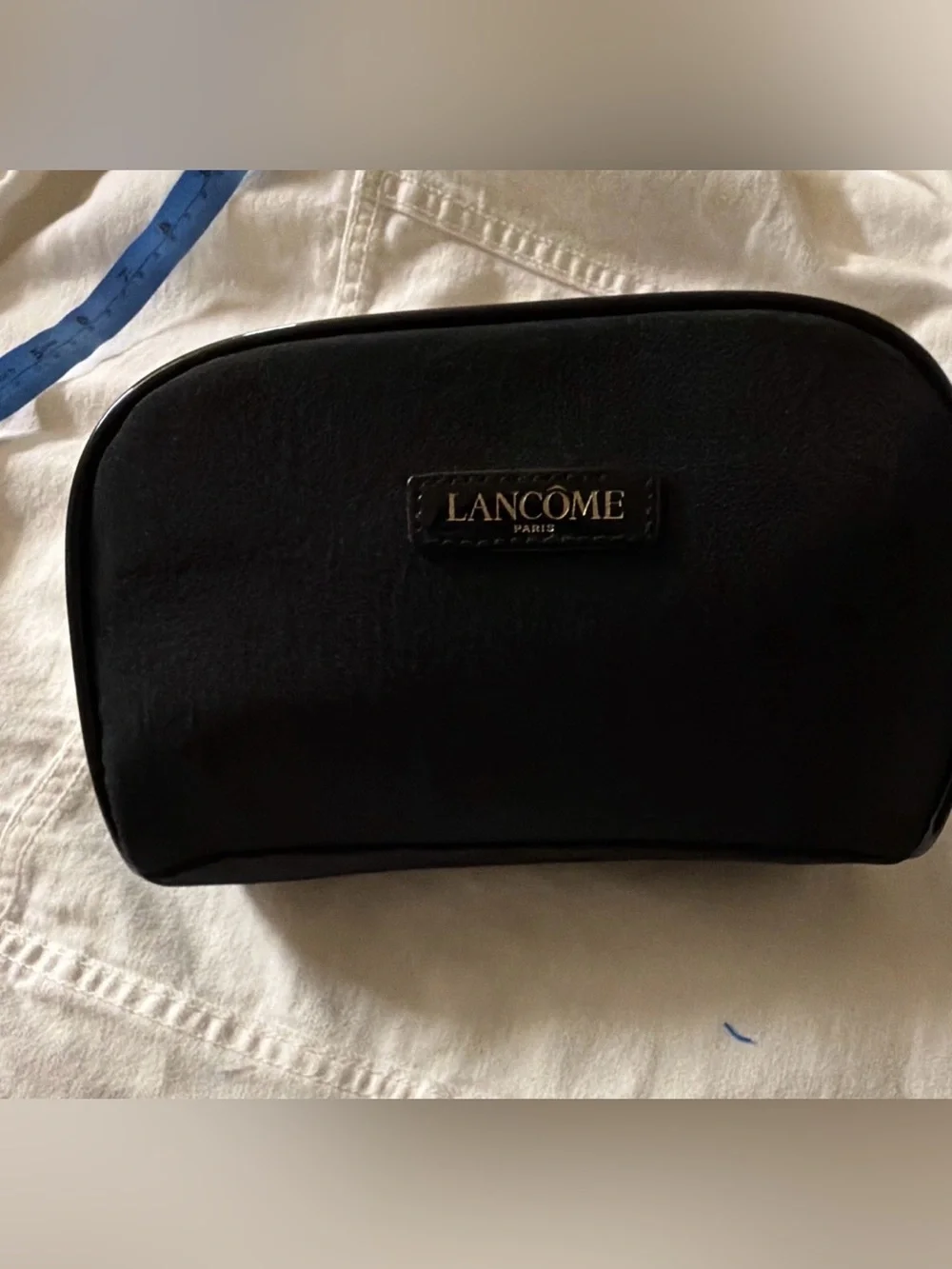 black faux-suede Lancôme Paris cosmetic pouch featuring a gold-lettered brand lo